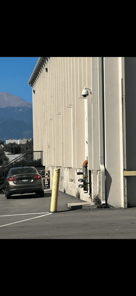 Alarm and fire safety equipment on commercial building exterior.